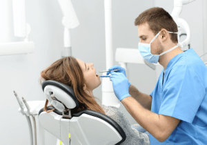 A young child having a comfortable dental check-up under the Canadian Dental Care Plan.